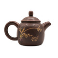 Kleine keramische theepot met decoratief motief 
