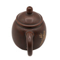 Kleine keramische theepot met decoratief motief 