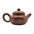 Keramische theepot met deksel en decoratief motief 