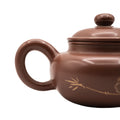Keramische theepot met deksel en decoratief motief 