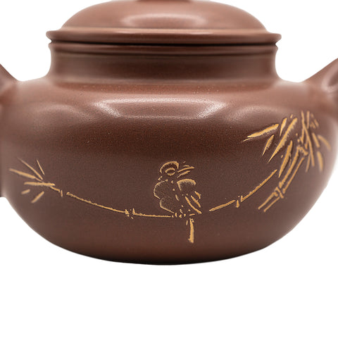 Keramische theepot met deksel en decoratief motief 