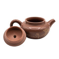 Keramische theepot met deksel en decoratief motief 