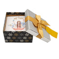 Gift box with a tea cakes titled  and a gold ribbon on a white background