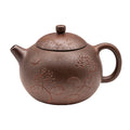 Peony Little Xi Shi woodfired yixing clay teapot with etched floral designs and a rounded body.