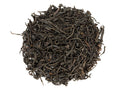 A close-up image of dry maroon-colored twisted leaves, indicative of Hong Yu Hong Cha black tea.