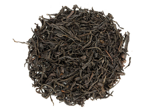 A close-up image of dry maroon-colored twisted leaves, indicative of Hong Yu Hong Cha black tea.