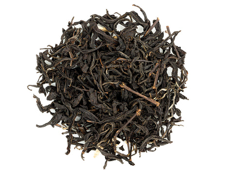 A close-up of Taiwanese Earl Grey black tea leaves with bergamot zest incorporated within.